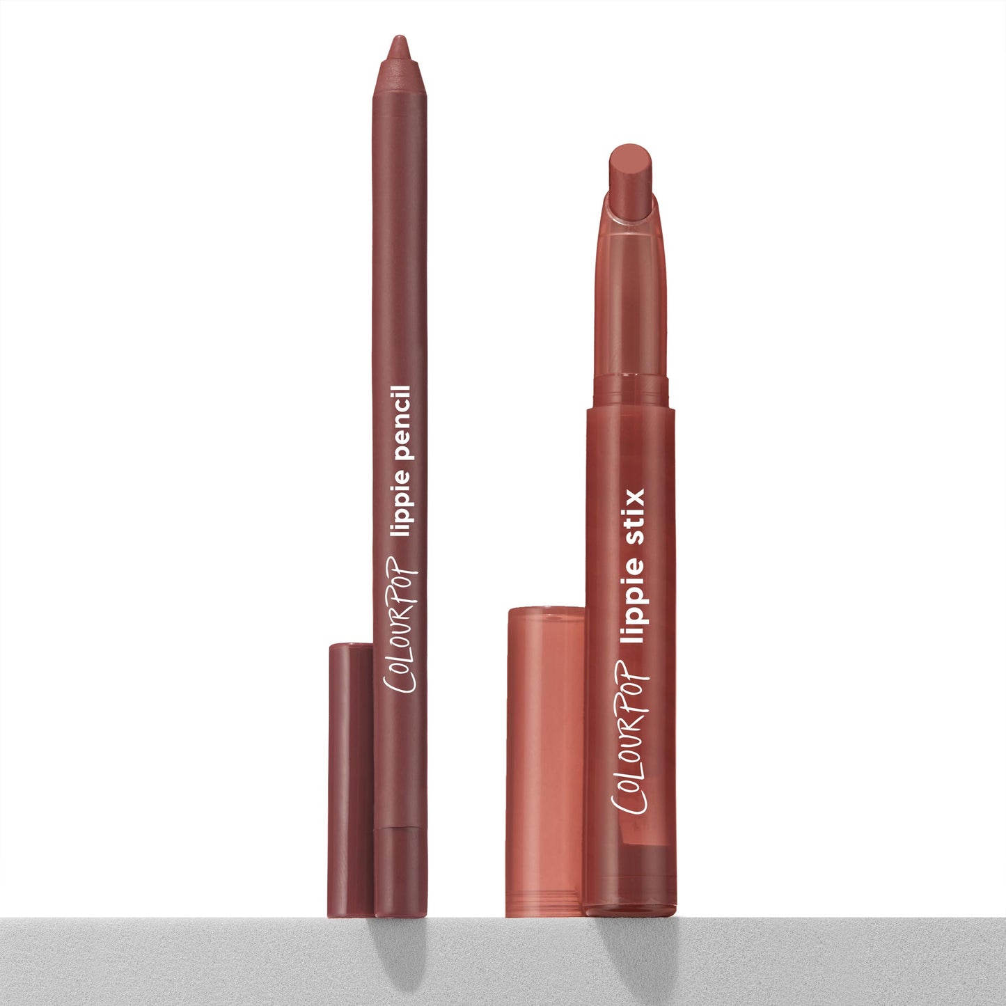 Big Smooch ColourPop Lippie Stix + Pencil Set stands uncapped on a white surface, the warm rose-mauve lip liner and matching twist-up lipstick upright with caps beside them in a clean, studio-lit product shot.