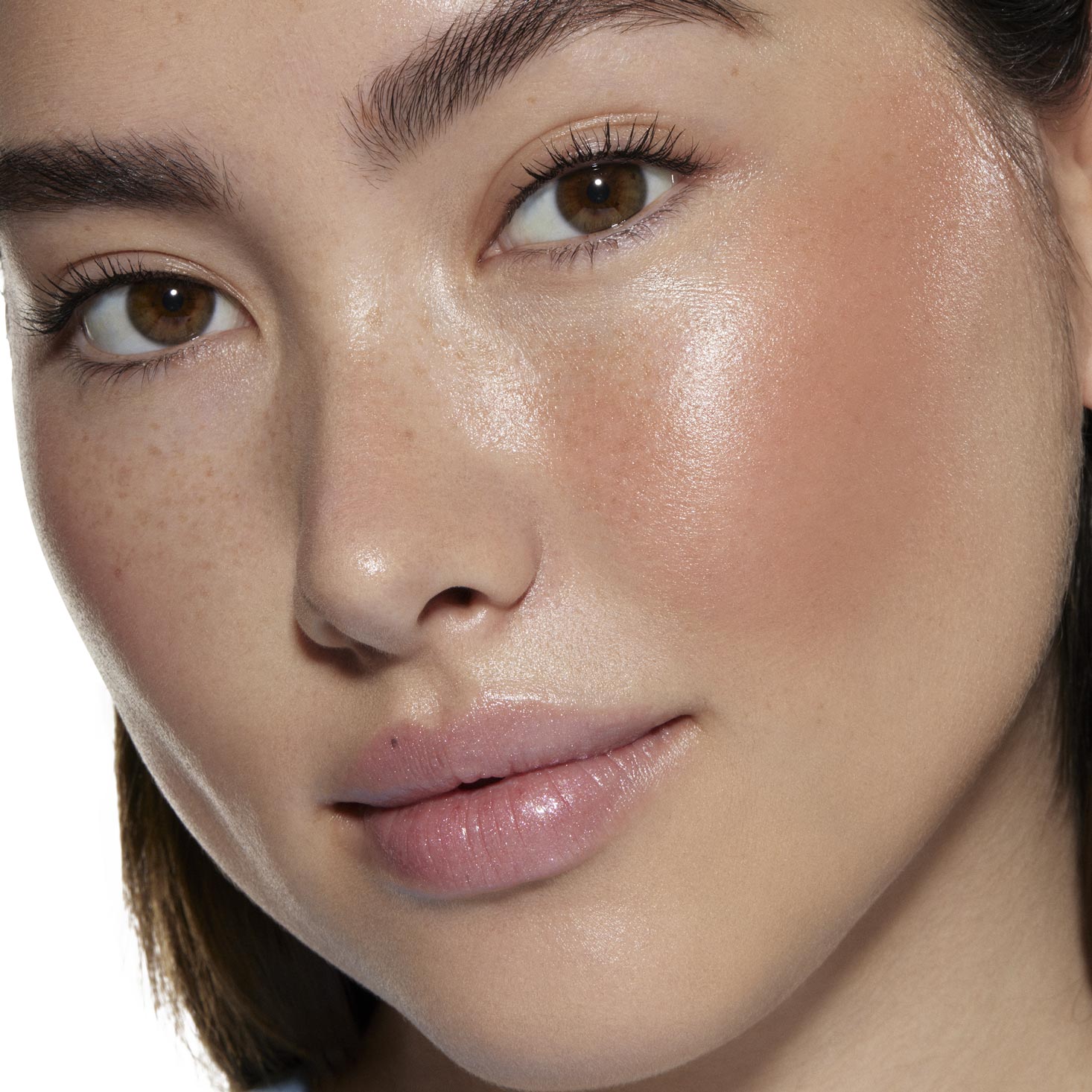 City Walk ColourPop Liquid Blush delivering a dewy peachy-pink flush on a model’s cheek, catching studio light; close-up showcases natural freckles, smooth skin, and the blendable liquid formula’s radiant, long-wear glow.